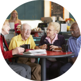 group of elderly talking and smiling to each other